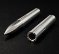 Two metal cylindrical objects on a black background