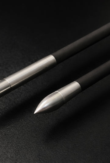 Three arrow shafts. Each with different ends on black background