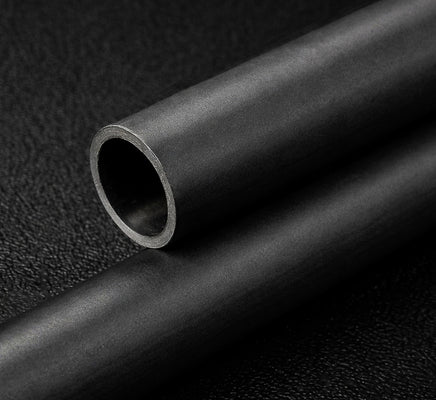 Close-up of a black carbon tube on a textured black background
